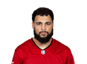 A person with a beard wearing a red jersey

Description automatically generated